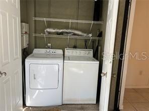 laundry room with separate washer and dryer and tile patterned floors