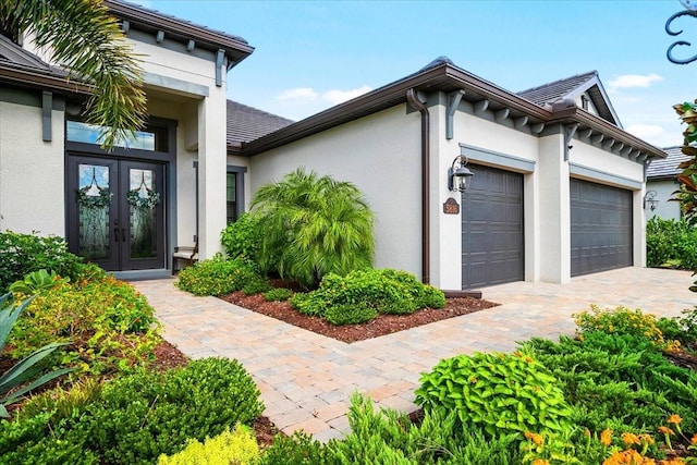 exterior space with french doors and a garage