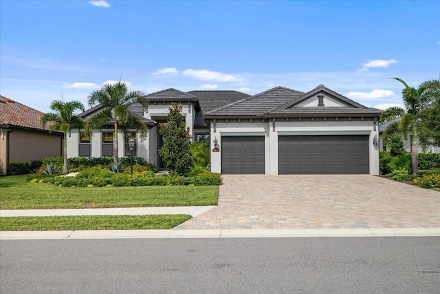 view of front of home with a front lawn and a garage