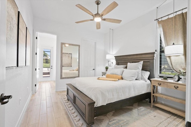 bedroom with access to exterior, light hardwood / wood-style floors, and ceiling fan