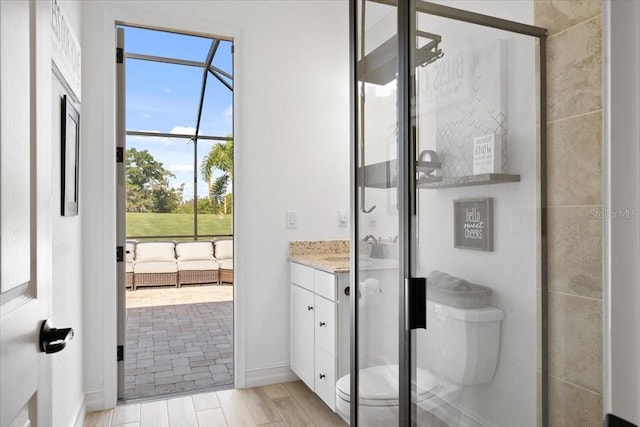 bathroom featuring vanity, toilet, and an enclosed shower