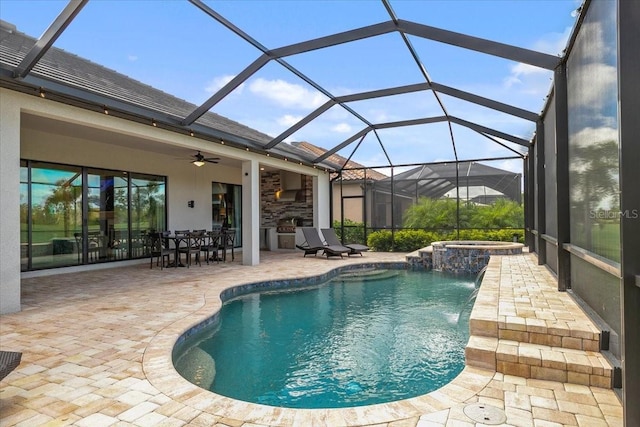 view of swimming pool with glass enclosure, pool water feature, ceiling fan, an in ground hot tub, and a patio