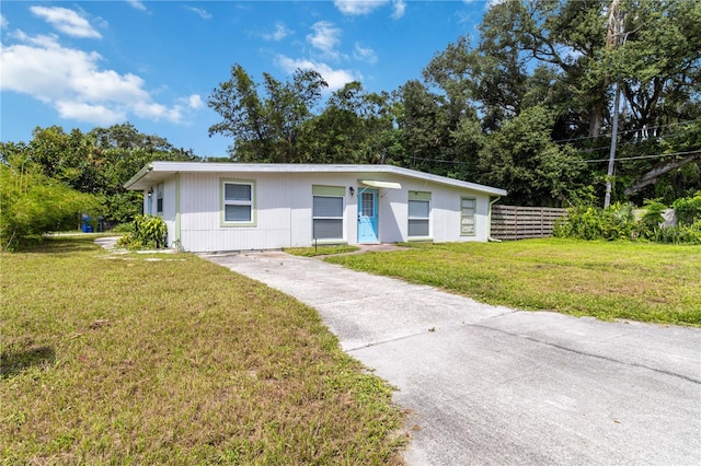 ranch-style house with a front lawn