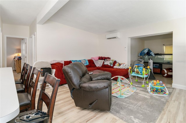 living room with an AC wall unit and hardwood / wood-style floors