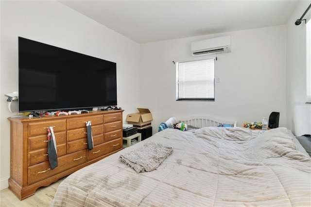 bedroom featuring a wall unit AC