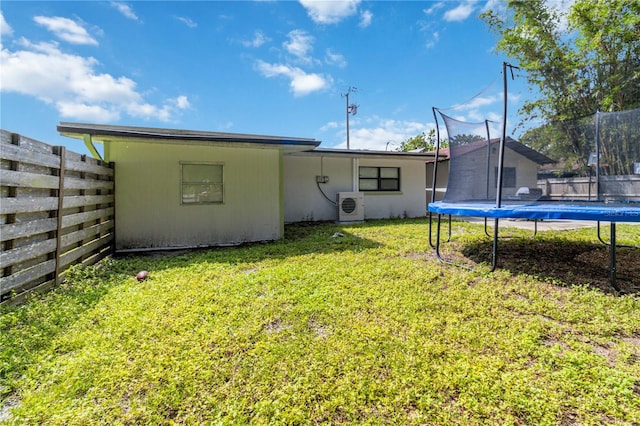 view of yard with ac unit and a trampoline