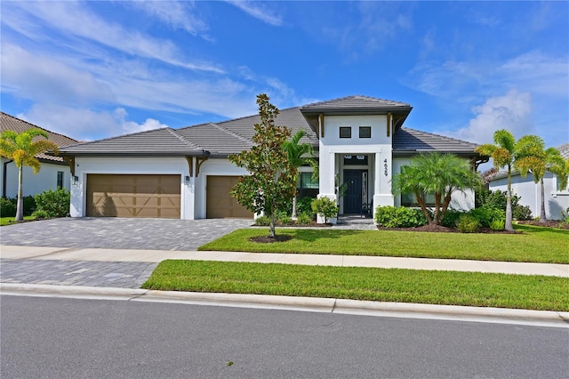 view of front facade with a front yard and a garage