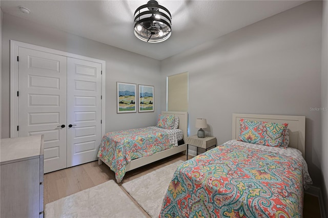 bedroom with a closet and light hardwood / wood-style flooring