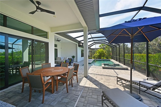 view of patio / terrace with ceiling fan, a swimming pool with hot tub, an outdoor living space, and glass enclosure