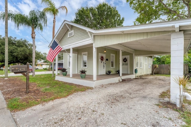 view of front of home with covered porch and a carport