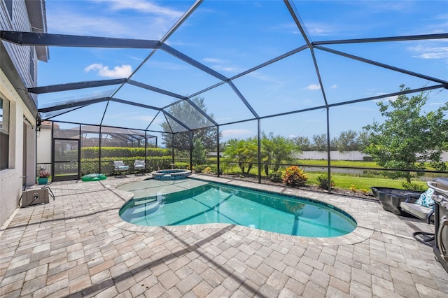 view of swimming pool with glass enclosure, an in ground hot tub, and a patio area