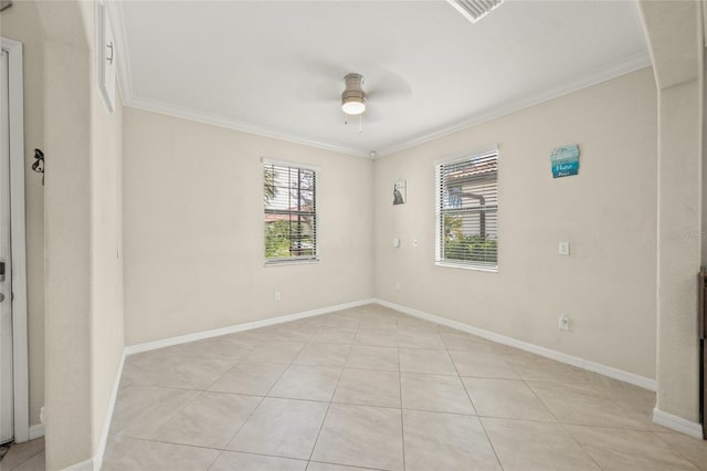 empty room featuring ceiling fan, light tile patterned floors, and crown molding