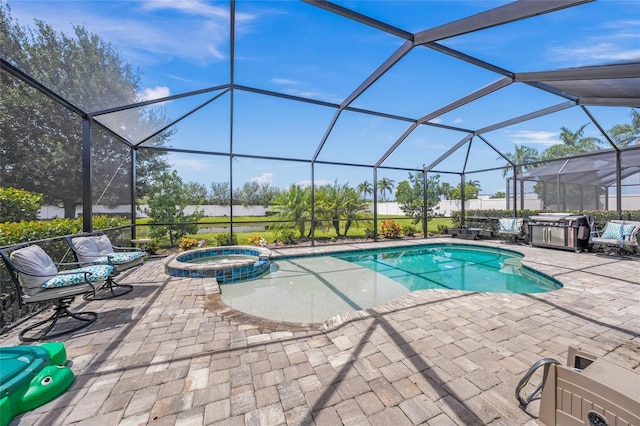 view of swimming pool with a lanai, a patio, and an in ground hot tub