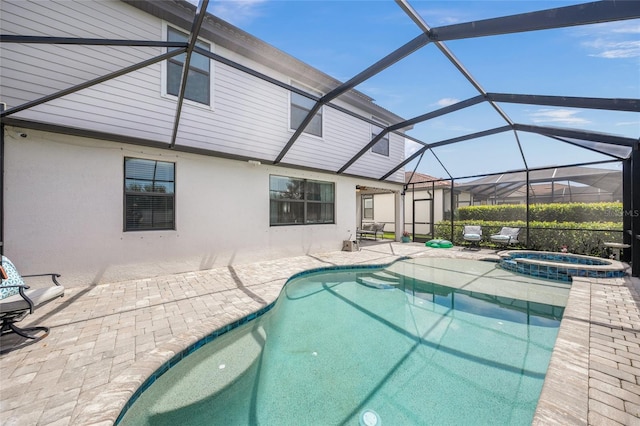 view of swimming pool featuring a lanai, an in ground hot tub, and a patio area