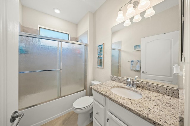 full bathroom featuring enclosed tub / shower combo, vanity, tile patterned flooring, and toilet