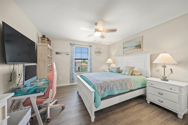 bedroom with dark hardwood / wood-style flooring and ceiling fan