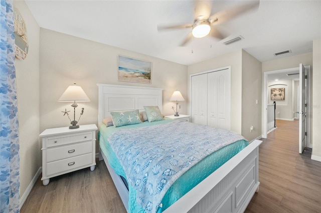 bedroom with ceiling fan, a closet, and hardwood / wood-style floors