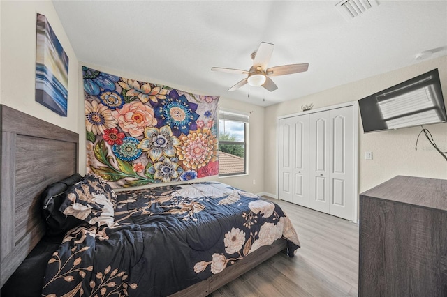 bedroom featuring a closet, light wood-type flooring, and ceiling fan