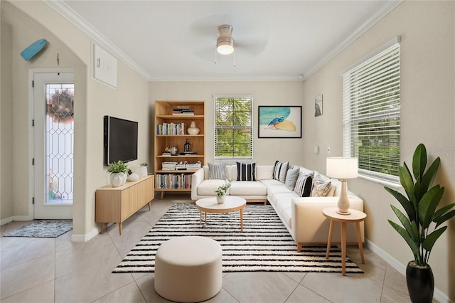 living room featuring ceiling fan, plenty of natural light, and ornamental molding