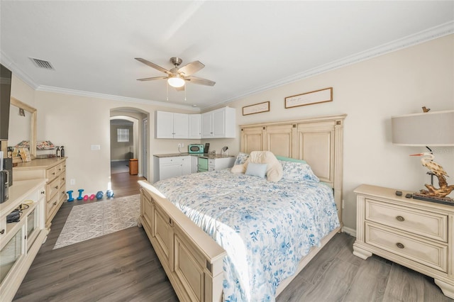 bedroom with ornamental molding, ceiling fan, and dark hardwood / wood-style flooring