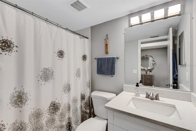 bathroom featuring curtained shower, toilet, and vanity