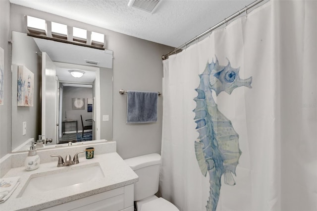 bathroom featuring a textured ceiling, vanity, toilet, and a shower with shower curtain