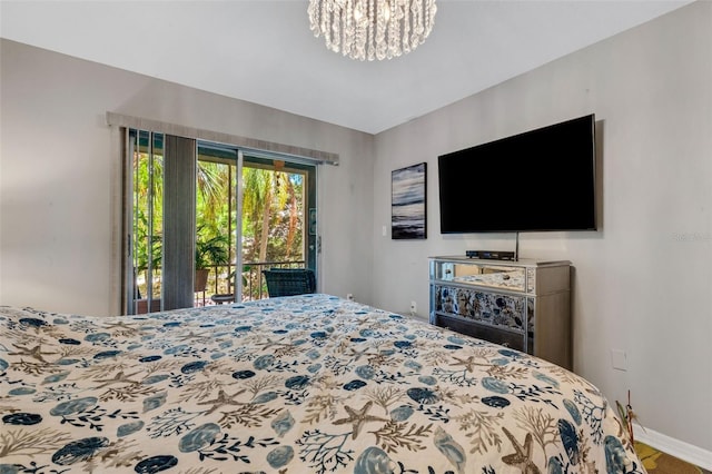 bedroom featuring an inviting chandelier and access to outside