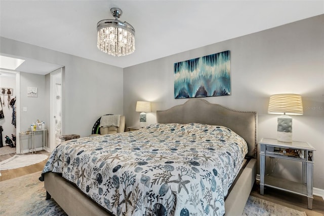 bedroom featuring hardwood / wood-style floors and a notable chandelier