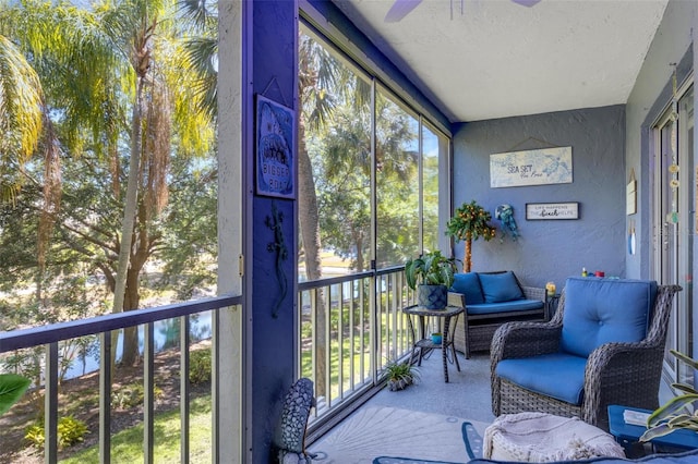 sunroom / solarium featuring ceiling fan