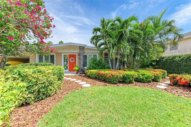 136 Crescent Dr, Anna Maria, FL 34216 - ranch-style home with a front yard