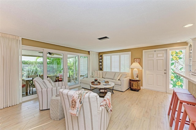 136 Crescent Dr, Anna Maria, FL 34216 - living area with plenty of natural light, light wood-type flooring, a textured ceiling, and visible vents