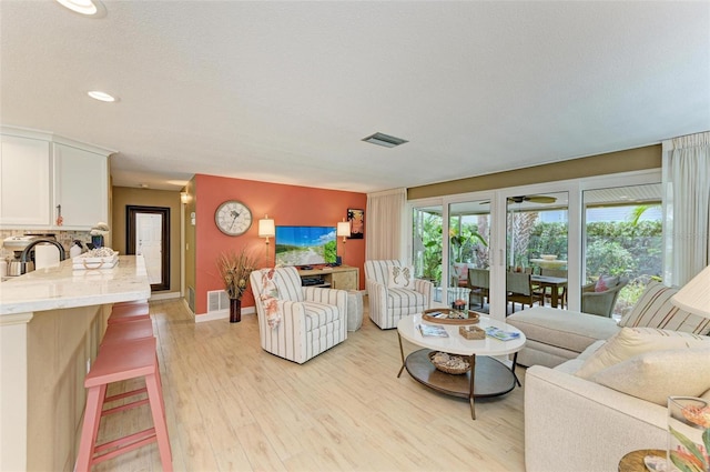 136 Crescent Dr, Anna Maria, FL 34216 - living room with recessed lighting, baseboards, light wood finished floors, and visible vents