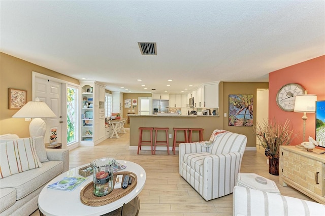 136 Crescent Dr, Anna Maria, FL 34216 - living room featuring recessed lighting, baseboards, light wood-type flooring, and visible vents