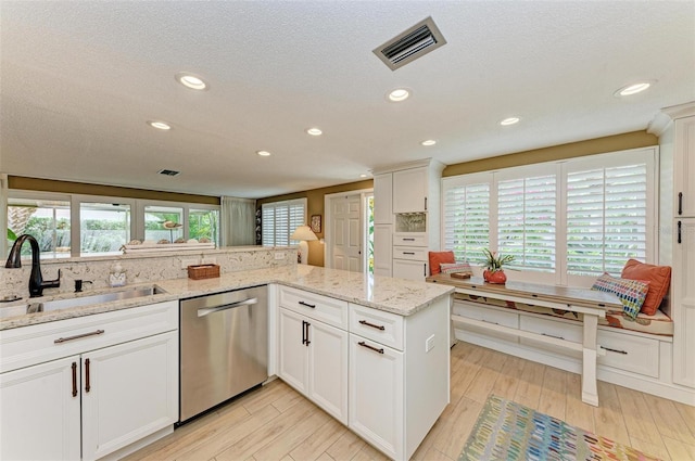 136 Crescent Dr, Anna Maria, FL 34216 - kitchen featuring visible vents, dishwasher, a sink, light wood finished floors, and recessed lighting