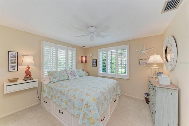 136 Crescent Dr, Anna Maria, FL 34216 - bedroom with baseboards, ceiling fan, light colored carpet, and visible vents