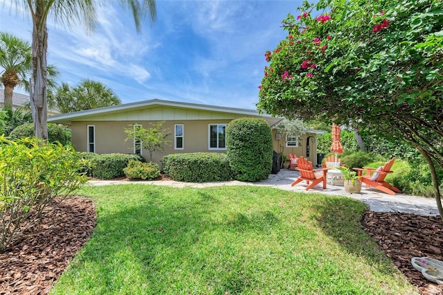 136 Crescent Dr, Anna Maria, FL 34216 - exterior space with a patio and a fire pit