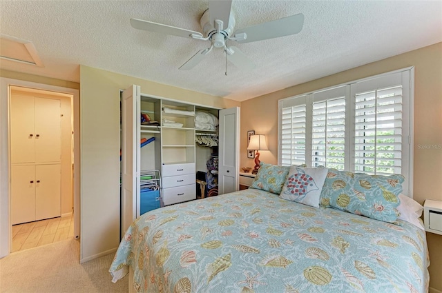136 Crescent Dr, Anna Maria, FL 34216 - carpeted bedroom with a textured ceiling, ceiling fan, and a closet