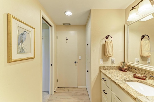 136 Crescent Dr, Anna Maria, FL 34216 - bathroom featuring vanity, baseboards, and visible vents