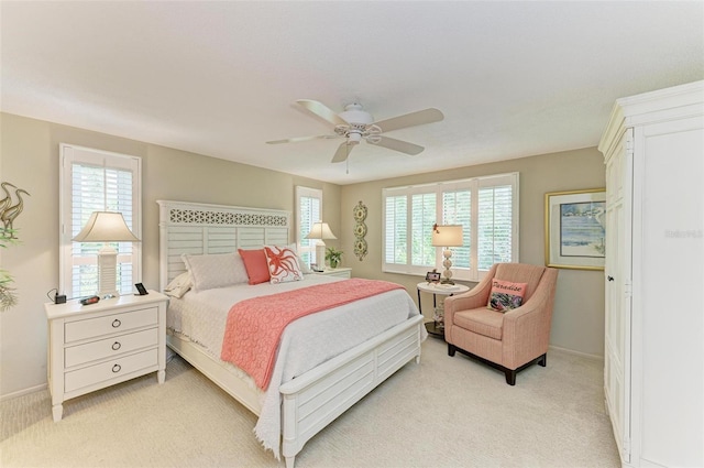 136 Crescent Dr, Anna Maria, FL 34216 - bedroom featuring baseboards, multiple windows, and light colored carpet