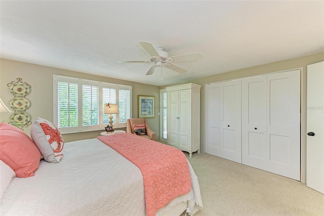 136 Crescent Dr, Anna Maria, FL 34216 - bedroom featuring two closets, a ceiling fan, and light carpet