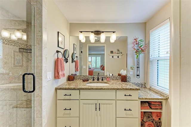 136 Crescent Dr, Anna Maria, FL 34216 - bathroom with a healthy amount of sunlight, vanity, a stall shower, and connected bathroom