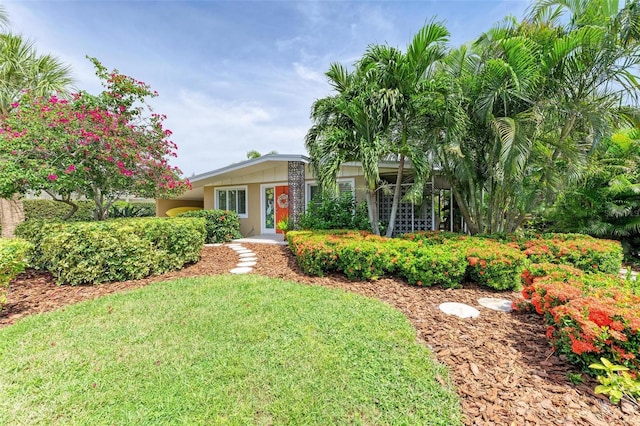 136 Crescent Dr, Anna Maria, FL 34216 - view of front facade featuring a front yard