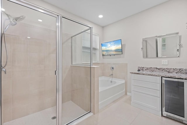 bathroom featuring vanity, beverage cooler, separate shower and tub, and tile patterned flooring