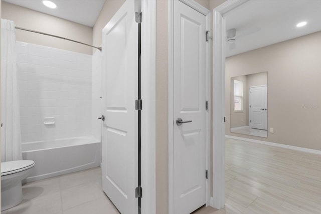 bathroom with shower / bath combo with shower curtain, toilet, and hardwood / wood-style flooring