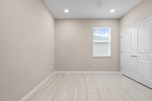 unfurnished bedroom featuring ceiling fan, a closet, and light hardwood / wood-style floors