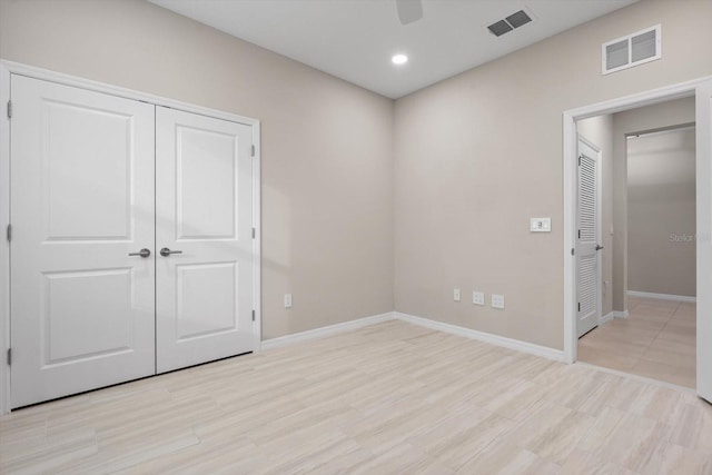 spare room featuring light wood-type flooring and ceiling fan