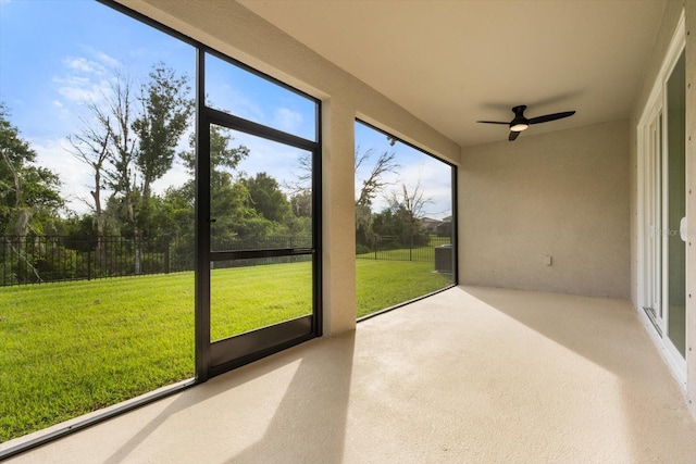 unfurnished sunroom with ceiling fan