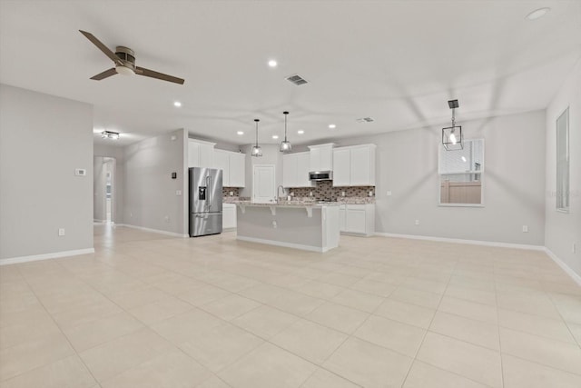 kitchen with ceiling fan, stainless steel appliances, white cabinetry, and hanging light fixtures