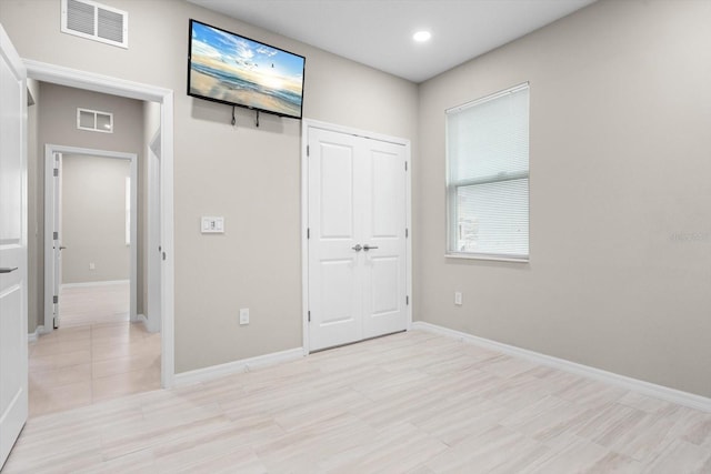 unfurnished bedroom with a closet and light tile patterned floors