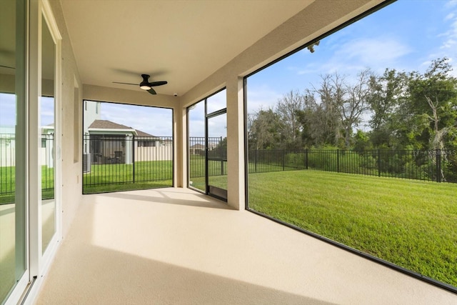 unfurnished sunroom featuring ceiling fan